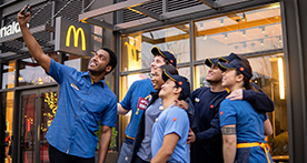 A group of McDonald’s employees smiling for a photo