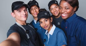 Five smiling McDonald's employees